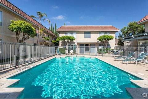 a large swimming pool in front of a house